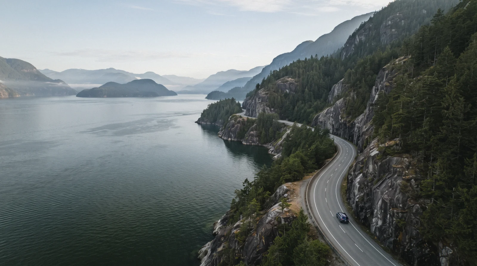The Sea to Sky Highway curving along Howe Sound north of Vancouver on a clear morning, Vancouver Canada