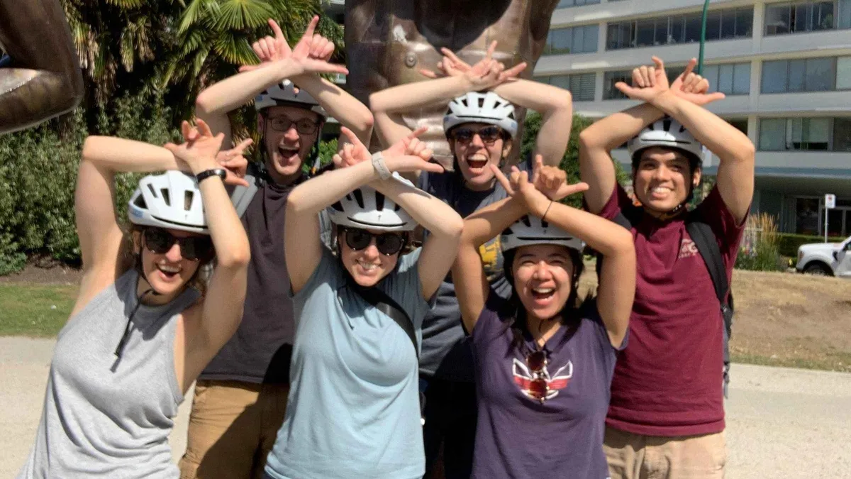 Cycling group beside old-growth cedars on a Stanley Park bike tour with e-bike upgrade, Vancouver