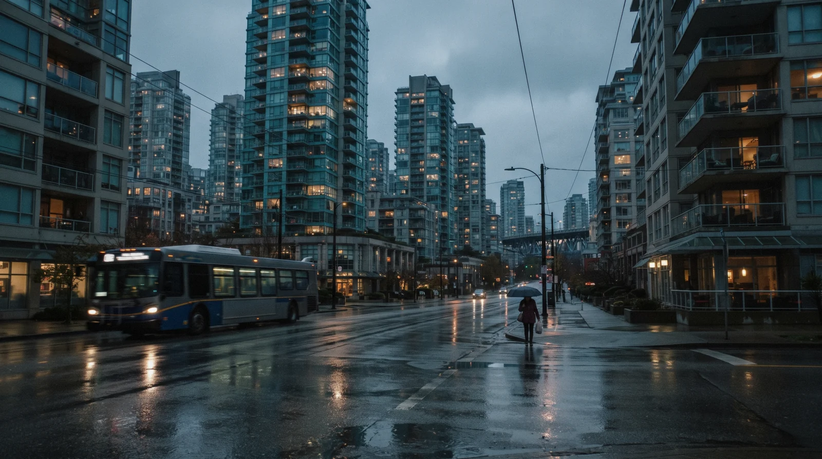 Downtown Vancouver towers above the Coal Harbour seawall at dusk with the North Shore mountains behind, the view that decides where to stay in Vancouver